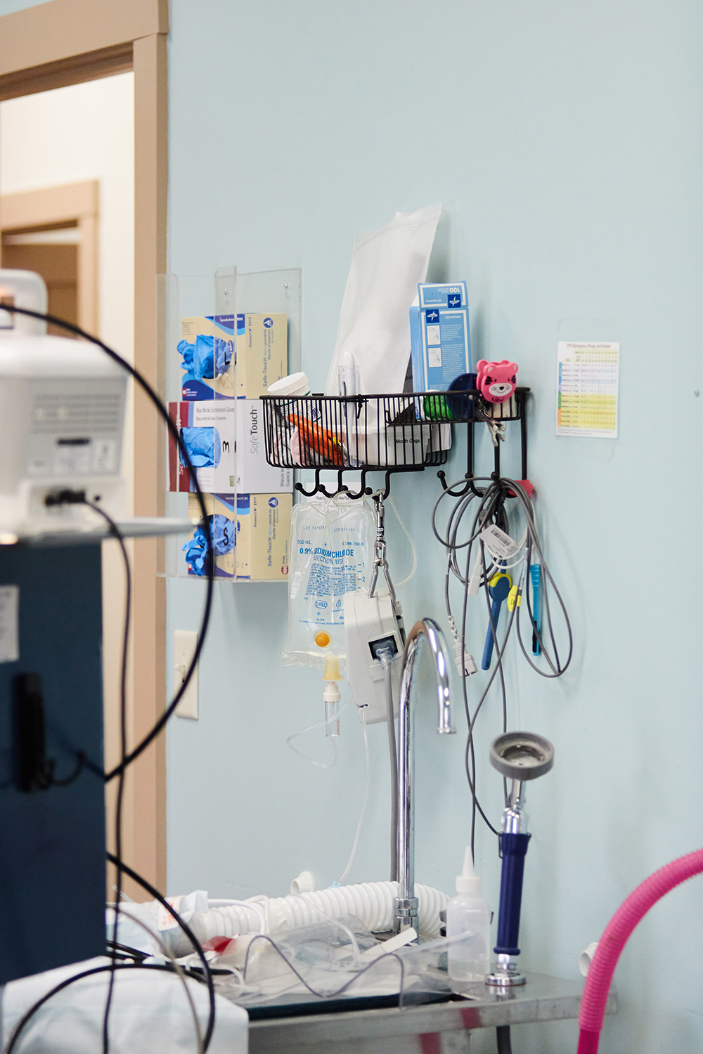 An image of various medical equipment that hangs on the wall at a doctors office.